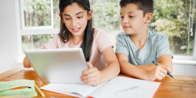 kids-studying-education-with-digital-tablet-for-online-school-work-or-homework-together-at-home-intelligent-distance-learning-students-children-or-siblings-of-brother-and-sister-help-with-lesson